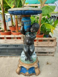 A highly decorative painted birdbath in the from of a young boy of colour holding the birdbath bowl on his shoulder.
H approx75cm
REF HH25723m35
Price £75