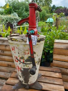 A red and white painted vintage oil dispensor with the words HYD OIL ONLY. A really attractive decorative piece for garden or shed display.