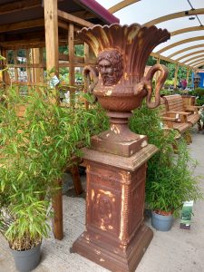 A pair of stunning cast iron urns on plinths. Lovely face detail on urn with serpent handles, and good rusty colour. The plinth bases are 50cm squared and stand around 83cm high. The urns are 75cm tall giving an overall height of over 1.5m. REF Whit01 Sold as a pair £1950